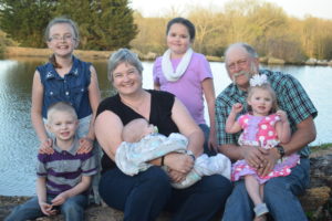 Susan, her husband and her five grandchildren.