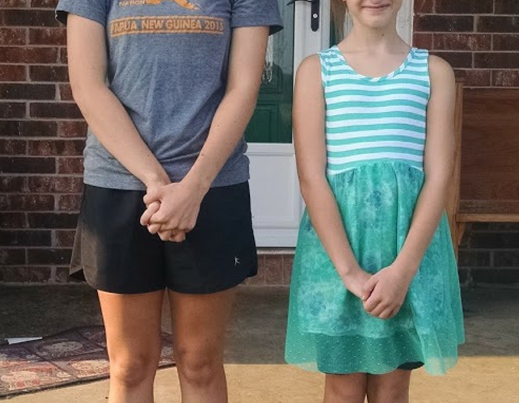 image of 2 girls on the first day of school